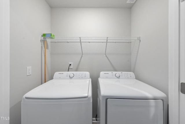 laundry area with washing machine and dryer