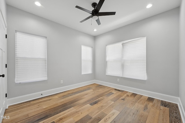 unfurnished room with wood finished floors, baseboards, recessed lighting, and a ceiling fan