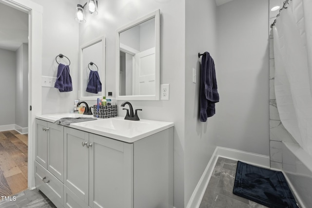 bathroom with baseboards and vanity