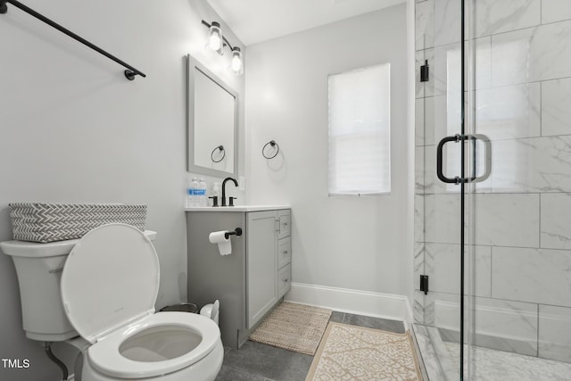 full bath with vanity, toilet, and a stall shower