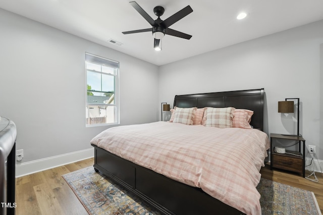 bedroom with a ceiling fan, light wood-type flooring, baseboards, visible vents, and recessed lighting