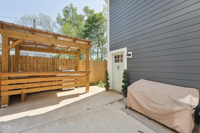 view of patio / terrace featuring fence and a grill