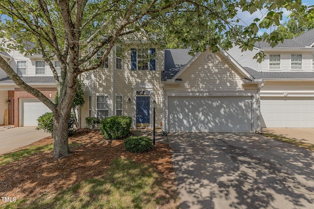 1031 Lake Moraine Pl, Raleigh, NC 27607 - view of front facade featuring concrete driveway, an attached garage, and a shingled roof