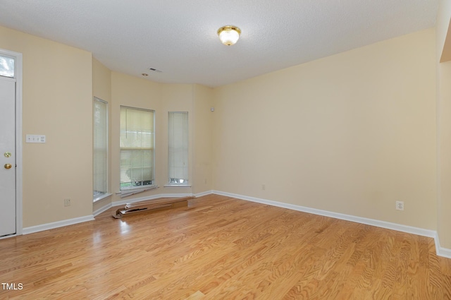 1031 Lake Moraine Pl, Raleigh, NC 27607 - spare room featuring wood finished floors, baseboards, and a textured ceiling