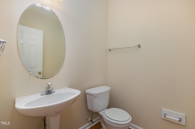 1031 Lake Moraine Pl, Raleigh, NC 27607 - bathroom with toilet, baseboards, and a sink