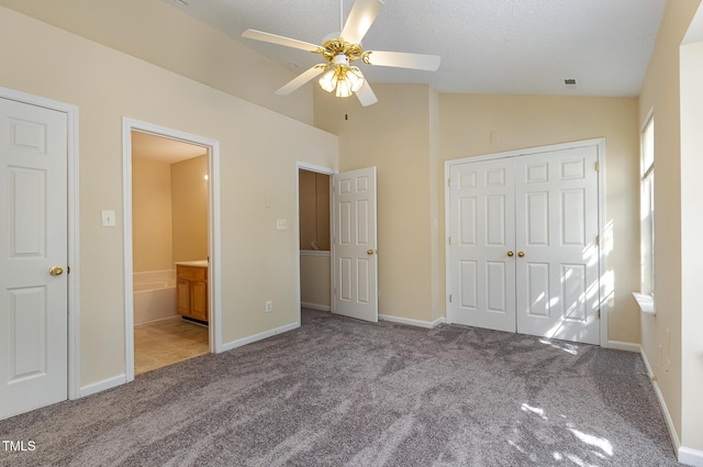 1031 Lake Moraine Pl, Raleigh, NC 27607 - unfurnished bedroom with carpet flooring, vaulted ceiling, a closet, connected bathroom, and baseboards