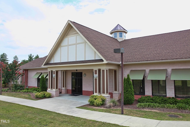 313 Carthage Ct, Durham, NC 27703 - view of front facade featuring covered porch, a shingled roof, and brick siding