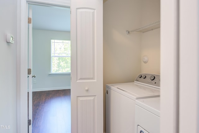 laundry room with baseboards, laundry area, dark wood-style floors, and washer and clothes dryer