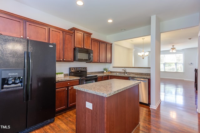 kitchen with a center island, a sink, black appliances, recessed lighting, and dark wood-type flooring
