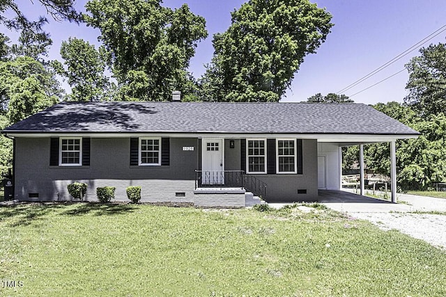 ranch-style home with brick siding, a carport, driveway, crawl space, and a front lawn