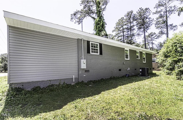 view of property exterior featuring crawl space, central AC unit, and a lawn