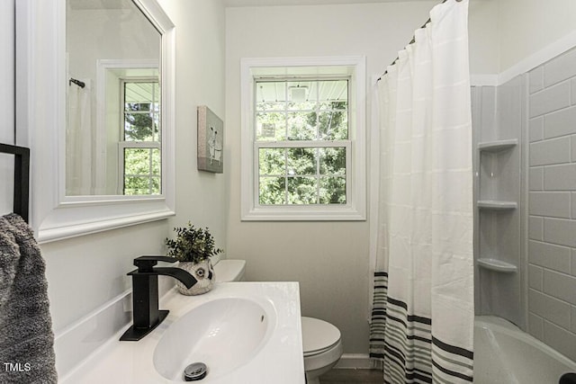 bathroom with shower / bathtub combination with curtain, vanity, and toilet