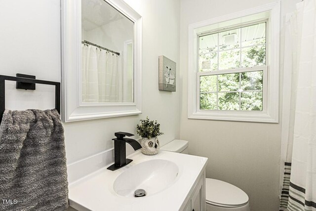 bathroom featuring toilet and vanity
