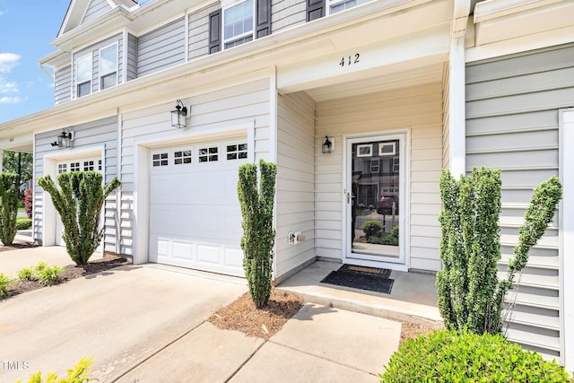 412 Stone Flower Ln, Raleigh, NC 27603 - view of exterior entry with an attached garage and concrete driveway