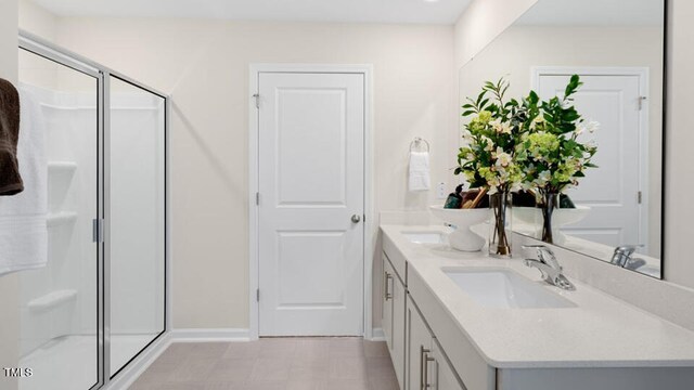 320 Hanging Elm Ln, Fuquay Varina, NC 27526 - full bath with baseboards, double vanity, a stall shower, and a sink
