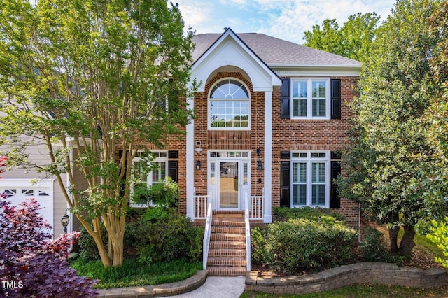 102 Traviliah Oaks Ln, Cary, NC 27518 - view of front of property with a shingled roof and brick siding