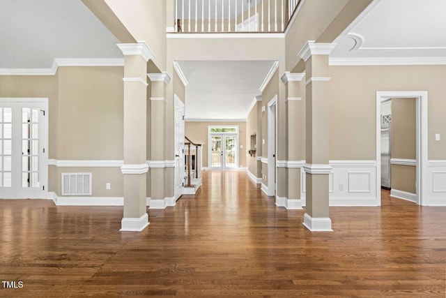 foyer entrance featuring wood finished floors, visible vents, and crown molding