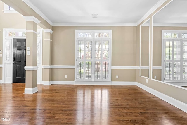 interior space with ornate columns, wood finished floors, and crown molding