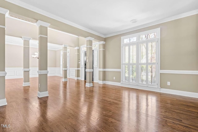 unfurnished living room with ornate columns, wood finished floors, and ornamental molding