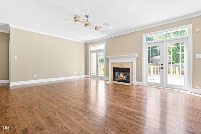 102 Traviliah Oaks Ln, Cary, NC 27518 - unfurnished living room featuring ornamental molding, ceiling fan, wood finished floors, and french doors