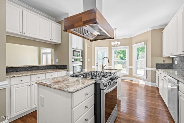 kitchen featuring island range hood, a kitchen island with sink, stainless steel appliances, a sink, and crown molding