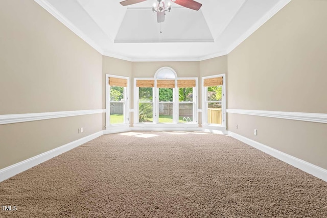 carpeted empty room featuring baseboards, high vaulted ceiling, ceiling fan, and a tray ceiling