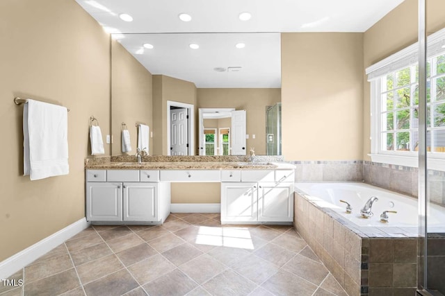 full bath featuring double vanity, a bath, a stall shower, and a sink