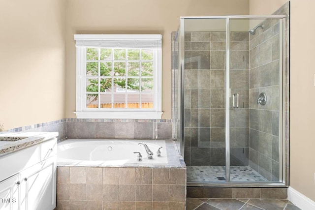 bathroom featuring a stall shower, a garden tub, tile patterned flooring, and vanity