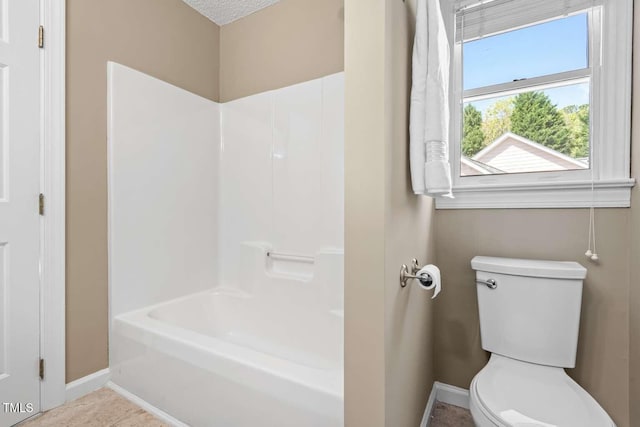 full bath with baseboards and toilet