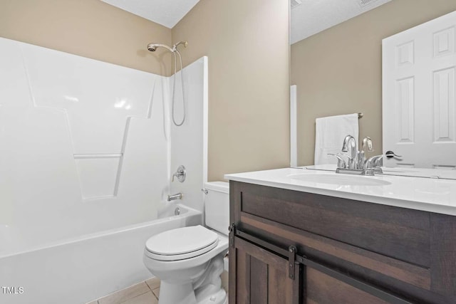 bathroom featuring vanity, toilet,  shower combination, and tile patterned flooring