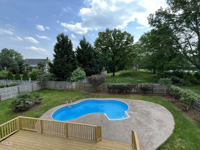view of swimming pool with a patio, a wooden deck, a fenced in pool, a yard, and a fenced backyard