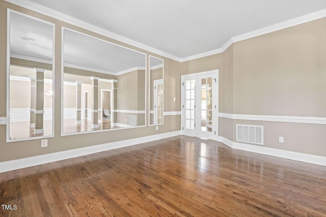 102 Traviliah Oaks Ln, Cary, NC 27518 - unfurnished room with wood finished floors, baseboards, crown molding, and decorative columns