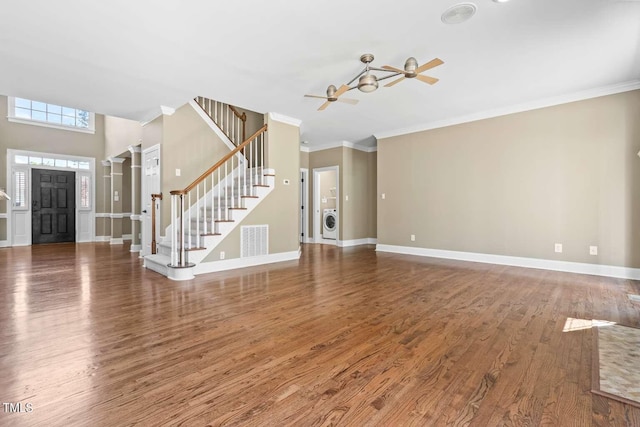 102 Traviliah Oaks Ln, Cary, NC 27518 - entrance foyer featuring a ceiling fan, washing machine and dryer, crown molding, wood finished floors, and baseboards