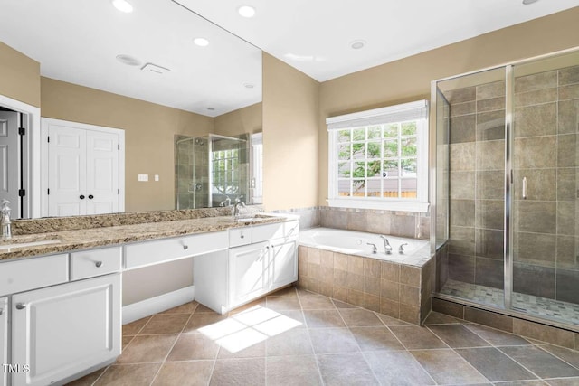 102 Traviliah Oaks Ln, Cary, NC 27518 - bathroom featuring double vanity, a stall shower, a bath, tile patterned floors, and recessed lighting