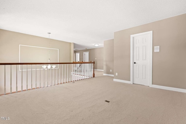 102 Traviliah Oaks Ln, Cary, NC 27518 - carpeted empty room with a chandelier, baseboards, and a textured ceiling