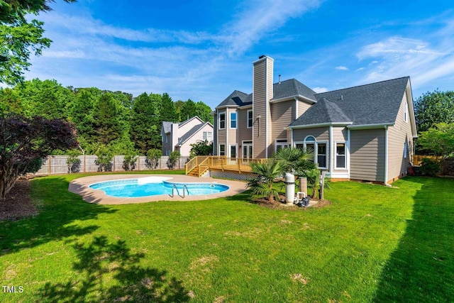 102 Traviliah Oaks Ln, Cary, NC 27518 - back of property featuring a wooden deck, a chimney, and a shingled roof
