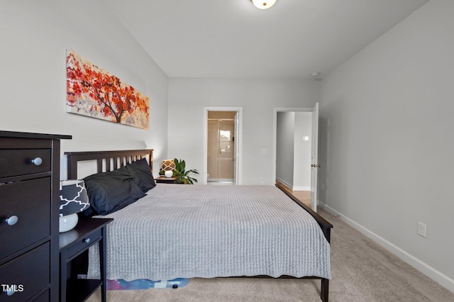 bedroom with carpet flooring, baseboards, and ensuite bathroom