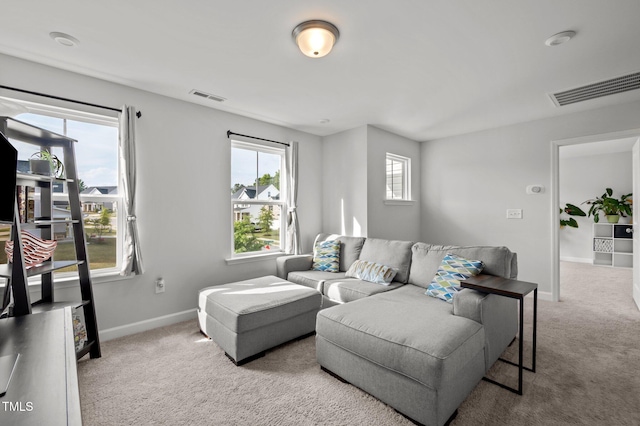carpeted living area with visible vents and baseboards