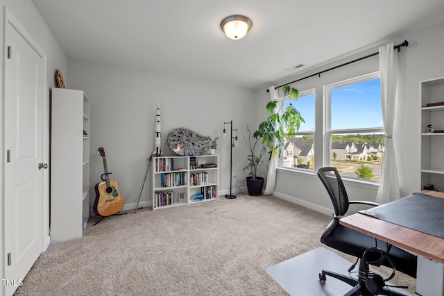 carpeted office with baseboards and visible vents
