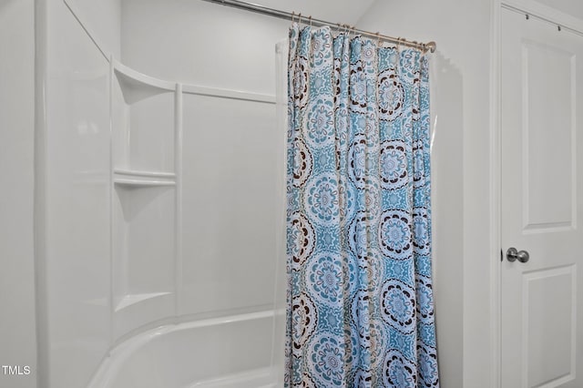 bathroom with shower / bath combo with shower curtain
