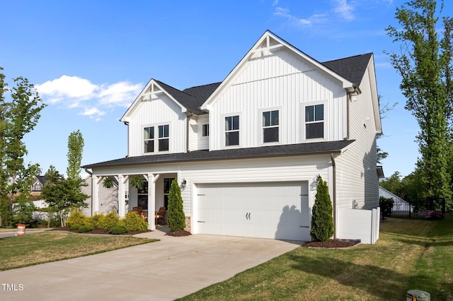 view of front of house featuring a porch, an attached garage, driveway, and a front yard
