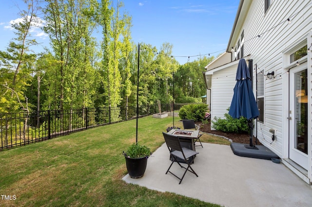 view of yard with a patio, a fenced backyard, and an outdoor fire pit