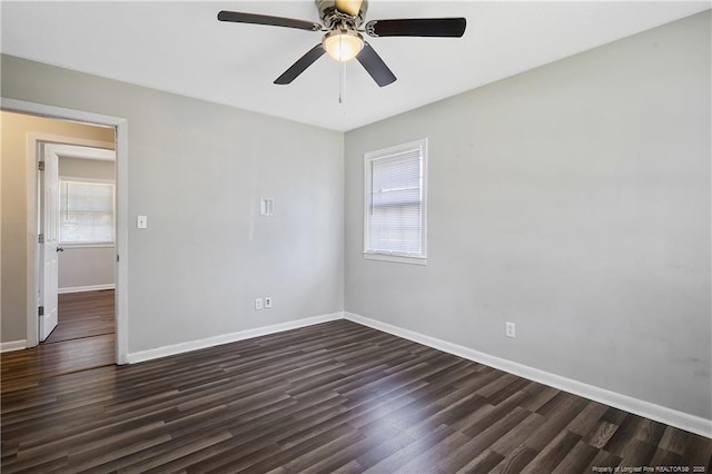 unfurnished room featuring dark wood-type flooring, baseboards, and ceiling fan