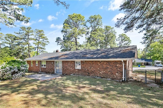 rear view of house with a patio area, fence, and a yard