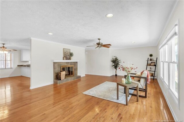 83 Pine Lake Dr, Whispering Pines, NC 28327 - living room with a textured ceiling, baseboards, and ceiling fan
