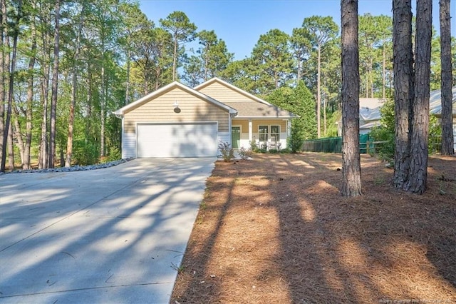 45 Martin Dr, Whispering Pines, NC 28327 - view of front facade featuring driveway and a garage
