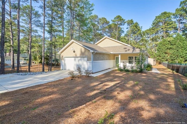 45 Martin Dr, Whispering Pines, NC 28327 - view of front of property with a garage and driveway