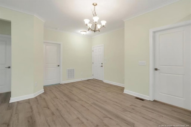 45 Martin Dr, Whispering Pines, NC 28327 - spare room with a chandelier, light wood-style flooring, and crown molding