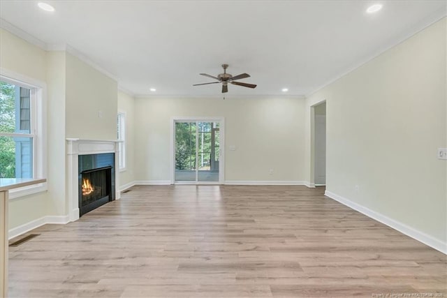 45 Martin Dr, Whispering Pines, NC 28327 - unfurnished living room with a ceiling fan, a lit fireplace, ornamental molding, light wood-type flooring, and recessed lighting