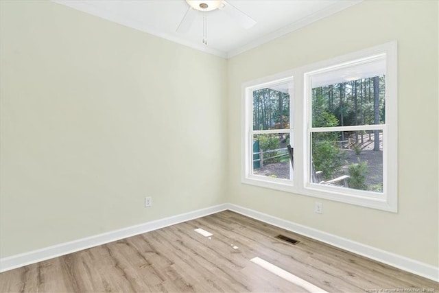 45 Martin Dr, Whispering Pines, NC 28327 - unfurnished room featuring plenty of natural light, wood finished floors, a ceiling fan, and ornamental molding